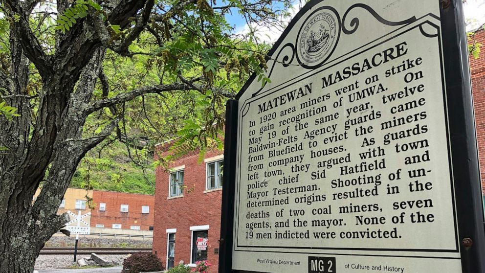 In this Tuesday, May 12, 2020, photo a historical sign stands outside a former post office in Matewan, W.Va. On May 19, 1920, a group of miners, who were led by a local police chief, and detectives hired by a coal company to evict unionizing miners f