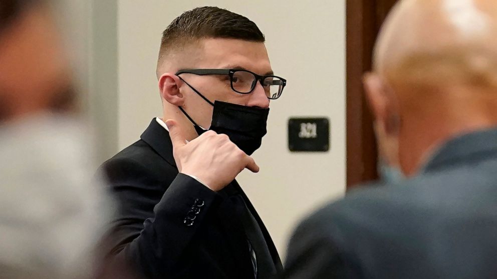Volodymyr Zhukovskyy, of West Springfield, Mass., charged with negligent homicide in the deaths of seven motorcycle club members in a 2019 crash, raises his hand while departing a courtroom at Coos County Superior Court in Lancaster, N.H., Tuesday, J