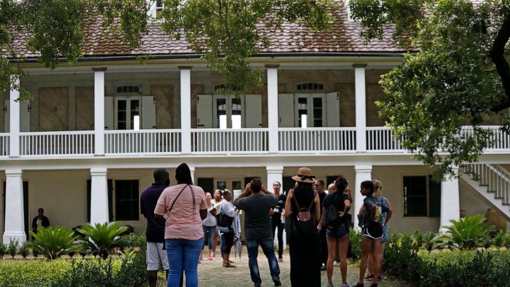 In this July 14, 2017 photo, visitors walk outside the main plantation house at the Whitney Plantation in Edgard, La. Descendants of slaves who lived and toiled in southeastern Louisiana won a key ruling Thursday, April 28, 2022 allowing their legal 