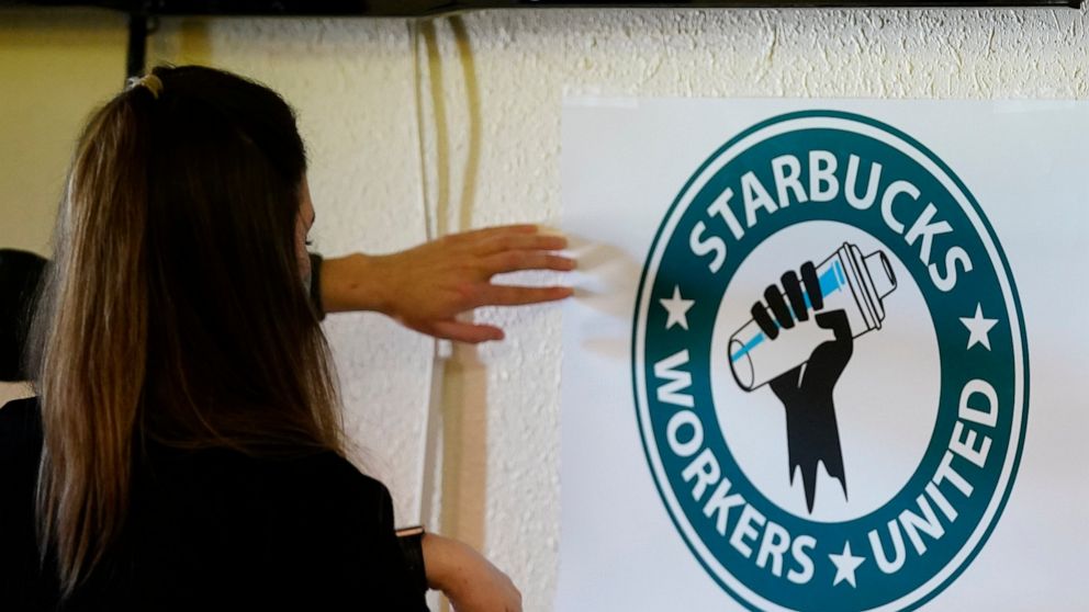 FILE - Michelle Eisen, a barista at the Buffalo, N.Y., Elmwood Starbucks location, helps out the local Starbucks Workers United, employees of a local Starbucks, as they gather at a local union hall to cast votes to unionize or not, on Feb. 16, 2022, 