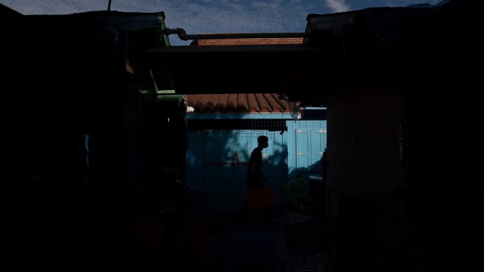 A man walks along Olvera Street Tuesday, June 8, 2021, in Los Angeles. Most businesses are no longer open daily and many have cut back to four or five days, said Valerie Hanley, treasurer of the Olvera Street Merchants Association Foundation and a sh