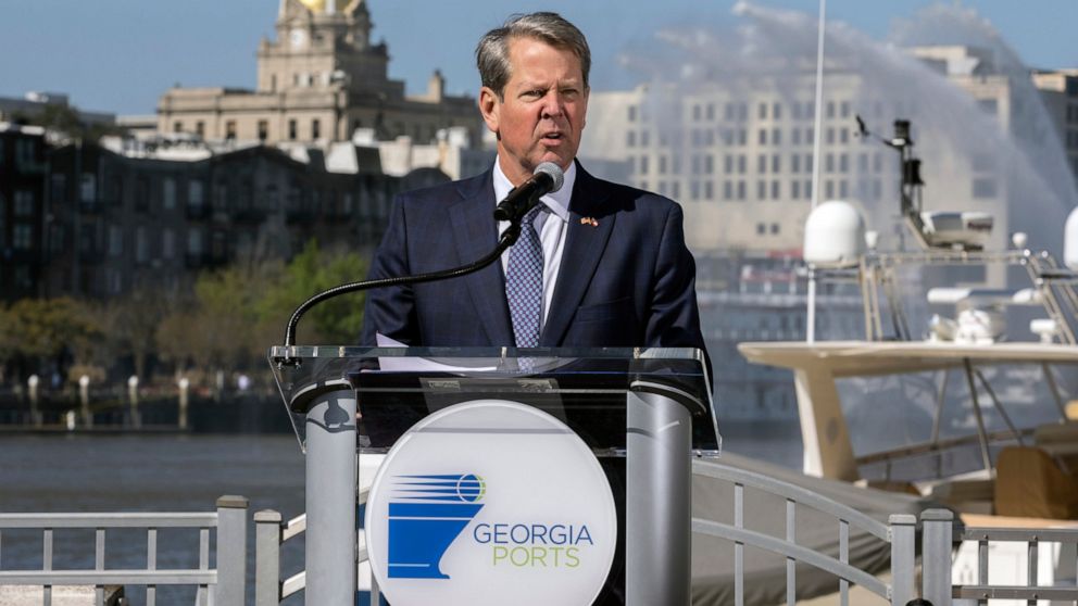 In this photo provided by the Georgia Ports Authority, Georgia Gov. Brian Kemp speaks at a ceremony marking completion of the Savannah Harbor deepening, Friday, March 25, 2022, in Savannah, Ga. Deepening the Savannah Harbor to 47 feet at mean low wat