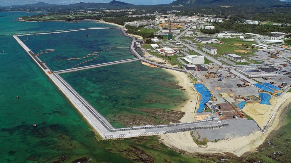 FILE - This Aug. 2018, file aerial photo shows preliminary construction work off Henoko, in Nago city, Okinawa prefecture, Japan, where the Japanese government plans to relocate a U.S. air base from one area of Okinawa's main island to another. A con