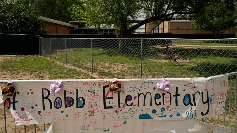 A sign with encouraging messages hangs at a memorial at Robb Elementary School created to honor the victims killed in the recent school shooting, Thursday, June 9, 2022, in Uvalde, Texas. The Texas elementary school where a gunman killed 19 children 