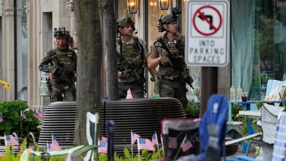 Law enforcement search after a mass shooting at the Highland Park Fourth of July parade in downtown Highland Park, Ill., a Chicago suburb on Monday, July 4, 2022. (AP Photo/Nam Y. Huh)