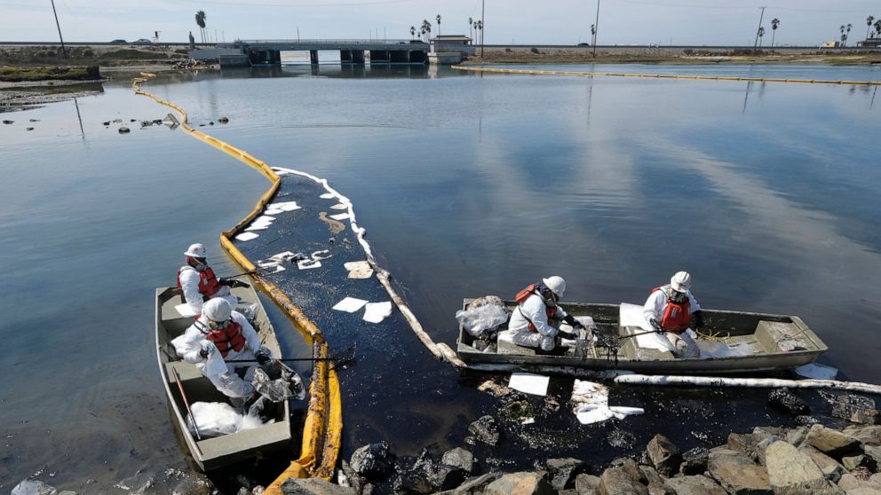 Cleanup contractors deploy skimmers and floating barriers known as booms to try to stop further oil crude incursion into the Wetlands Talbert Marsh in Huntington Beach, Calif., Sunday., Oct. 3, 2021. One of the largest oil spills in recent Southern C