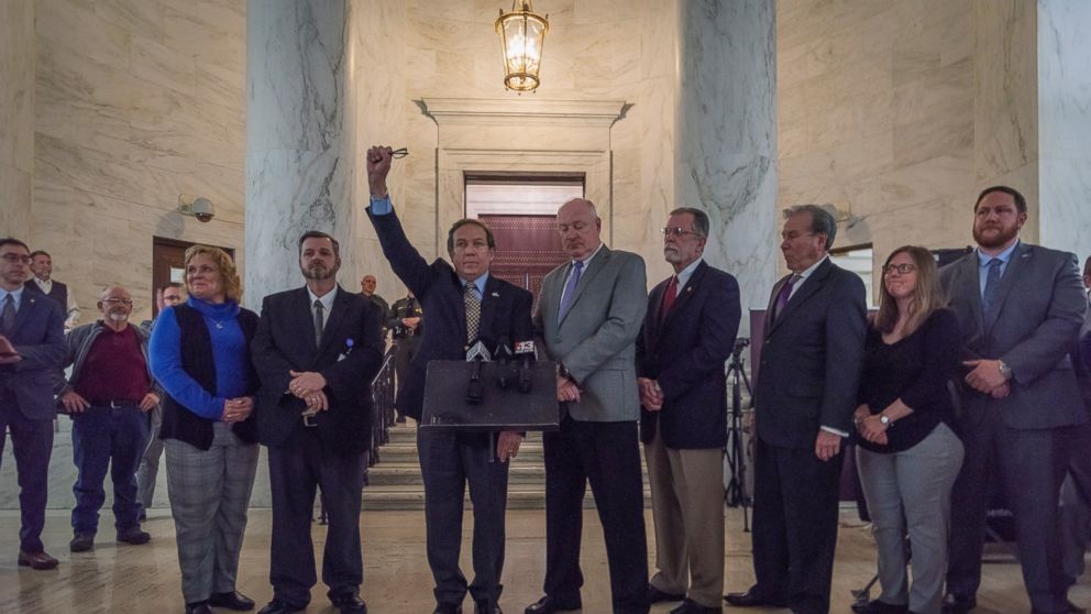 American Federation of Teachers West Virginia Treasurer Fred Albert, fist raised, and other union leaders of the WVEA, AFT-WV and WVSSPA call for a statewide strike beginning tomorrow during a news conference outside of the Senate chamber at the West
