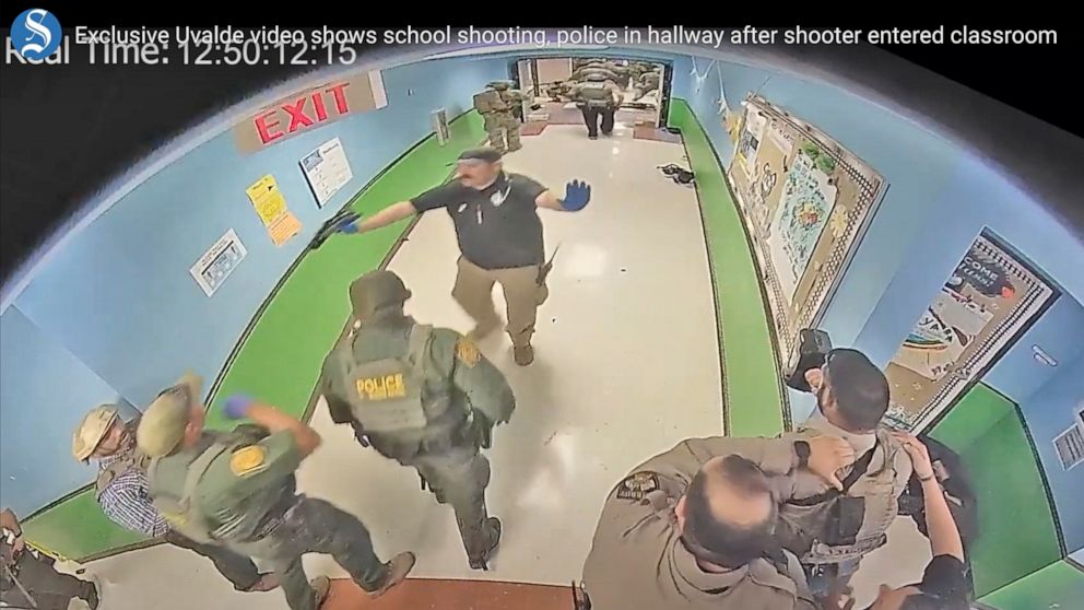 FILE - In this photo from surveillance video provided by the Uvalde Consolidated Independent School District via the Austin American-Statesman, authorities respond to the shooting at Robb Elementary School in Uvalde, Texas, on May 24, 2022. Nearly 40