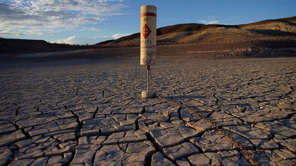 FILE - A buoy sits high and dry on cracked earth previously under the waters of Lake Mead at the Lake Mead National Recreation Area near Boulder City, Nev., on June 28, 2022. Living with less water in the U.S. Southwest is the focus for a conference 