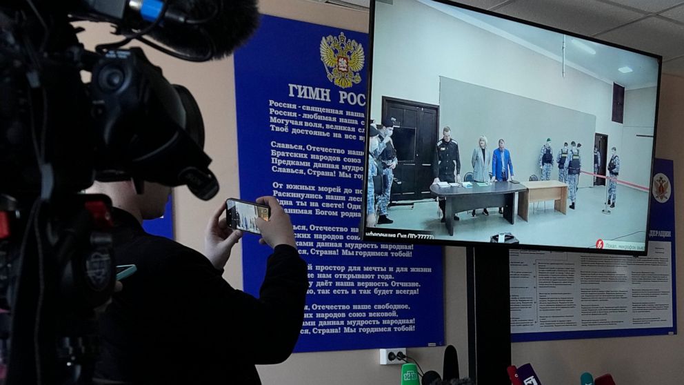 FIL E- Journalists film a TV screen translating a court session of Russian opposition leader Alexei Navalny, in Pokrov, Vladimir region, east of Moscow, Russia, March 22, 2022. (AP Photo, File)