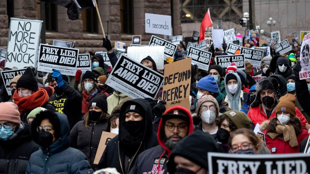 FILE - People march at a rally for Amir Locke on Saturday, Feb. 5, 2022, in Minneapolis. Minnesota prosecutors declined to file charges Wednesday, April 6, 2022, against a Minneapolis police SWAT team officer who fatally shot Amir Locke while executi