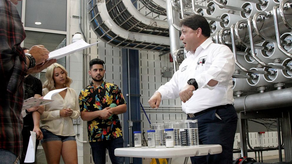 In this May 2, 2019 photo, El Paso Water worker Hector Sepulveda gives students from the University of Texas-El Paso a tour of a desalination plant in El Paso, Texas. Texas officials are struggling to ensure that they can sate everyone’s thirst as ab