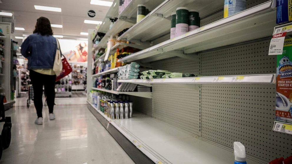 FILE - In this March 3, 2020 file photo, empty shelves for disinfectant wipes wait for restocking, as concerns grow around COVID-19, in New York. Legions of nervous hoarders are stocking up on canned goods, frozen dinners, toilet paper, and cleaning 