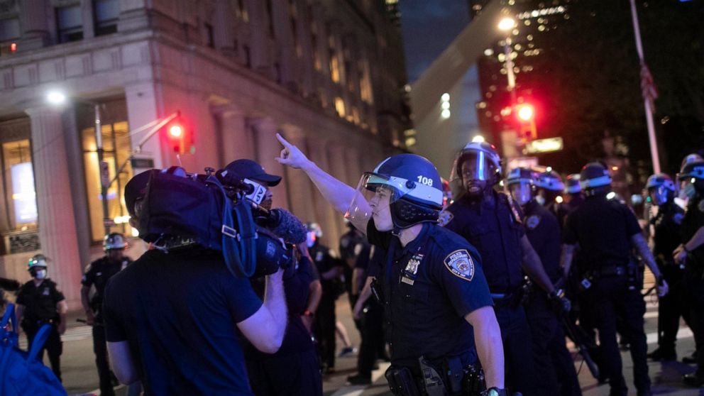 A police officer shouts at Associated Press videojournalist Robert Bumsted, Tuesday, June 2, 2020, in New York. New York City police officers surrounded, shoved and yelled expletives at two Associated Press journalists covering protests Tuesday in th