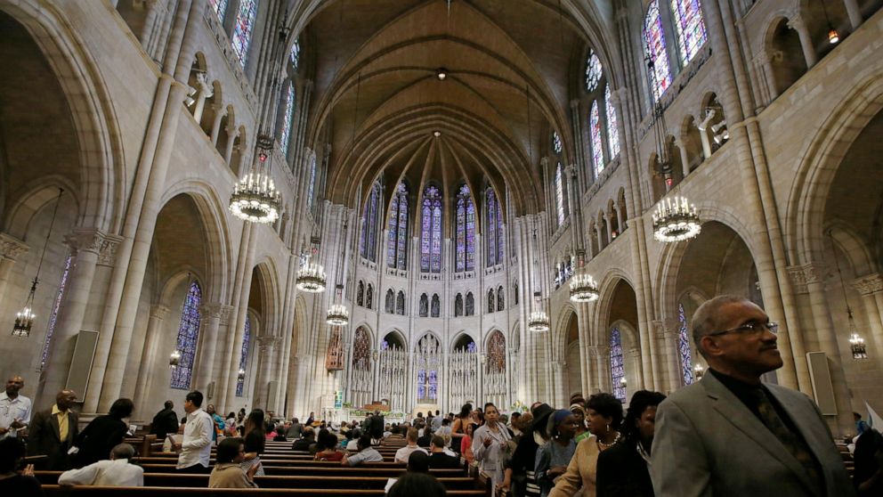 FILE - In this July 20, 2014 photo, members of the congregation file out after Sunday morning worship services at Riverside Church in New York. Fifty years ago, civil rights activist James Forman interrupted the Sunday worship service the church and 