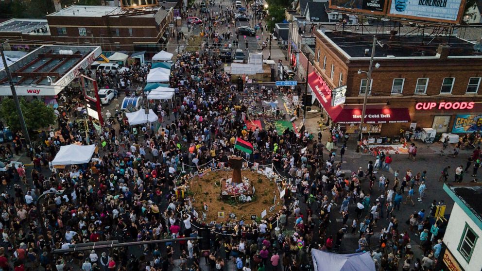 In a photo taken with a drone, people gather at George Floyd Square on the one-year anniversary of Floyd's death, Tuesday, May 25, 2021, in Minneapolis. (AP Photo/Christian Monterrosa)
