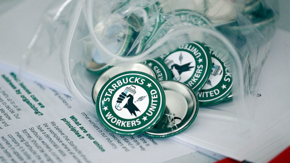 FILE - Pro-union pins sit on display, Dec. 9, 2021. Employees at a Starbucks store in New Orleans are the first of the coffee giant's locations in Louisiana to unionize, voting 11-1 in favor of joining a union on Friday and Saturday, June 3-4, 2022. 