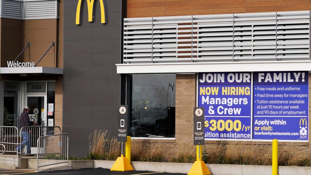 FILE - In this Nov. 19, 2020, file photo, a hiring sign is displayed outside of McDonald's in Buffalo Grove, Ill. On Wednesday, April 14, 2021, McDonald’s said the company will mandate worker training to combat harassment, discrimination and violence