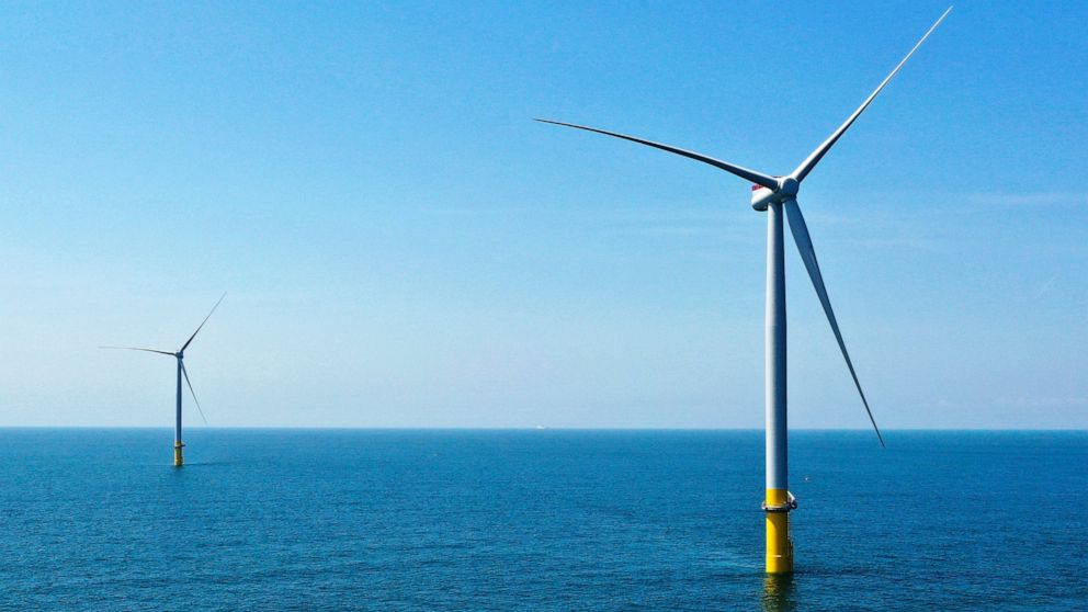 FILE - Two of the offshore wind turbines, which have been constructed off the coast of Virginia Beach, Va., are seen, June 29, 2020. Virginia regulators granted a critical approval Thursday, Dec. 15, 2022, for Dominion Energy's plans to construct and
