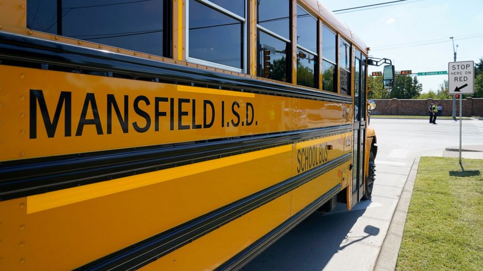 A Mansfield ISD school bus leaves the Center For The Performing Arts in Mansfield, Texas, Wednesday, Oct. 6, 2021, after dropping off school children from Timberview High School following a school shooting at Timberview. (AP Photo/Tony Gutierrez)