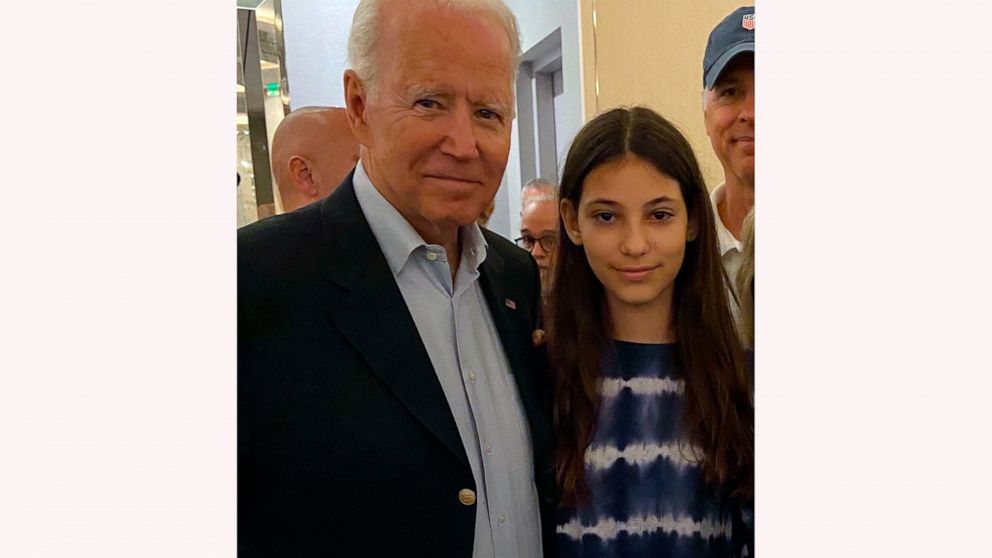 In this photo provided by a family member, 12-year-old Elisheva Cohen poses with President Joe Biden, Thursday, July 1, 2021, in Surfside, Fla., as the president and first lady visited the community devastated by the fatal collapse of the 12-story Ch