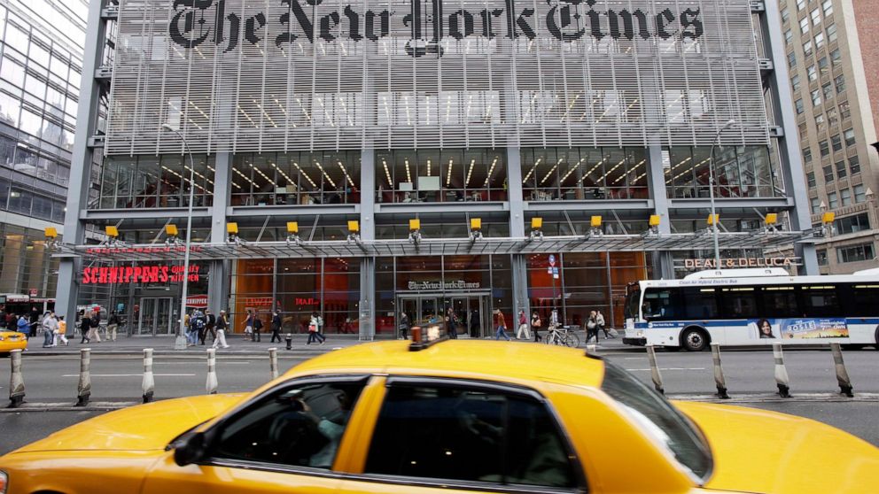 FILE - In this Oct. 20, 2011 file photo, traffic passes the New York Times building in New York. The publisher of The New York Times posted a 20% gain in fourth-quarter profits as the paper continued to add digital subscribers, although ad revenue de