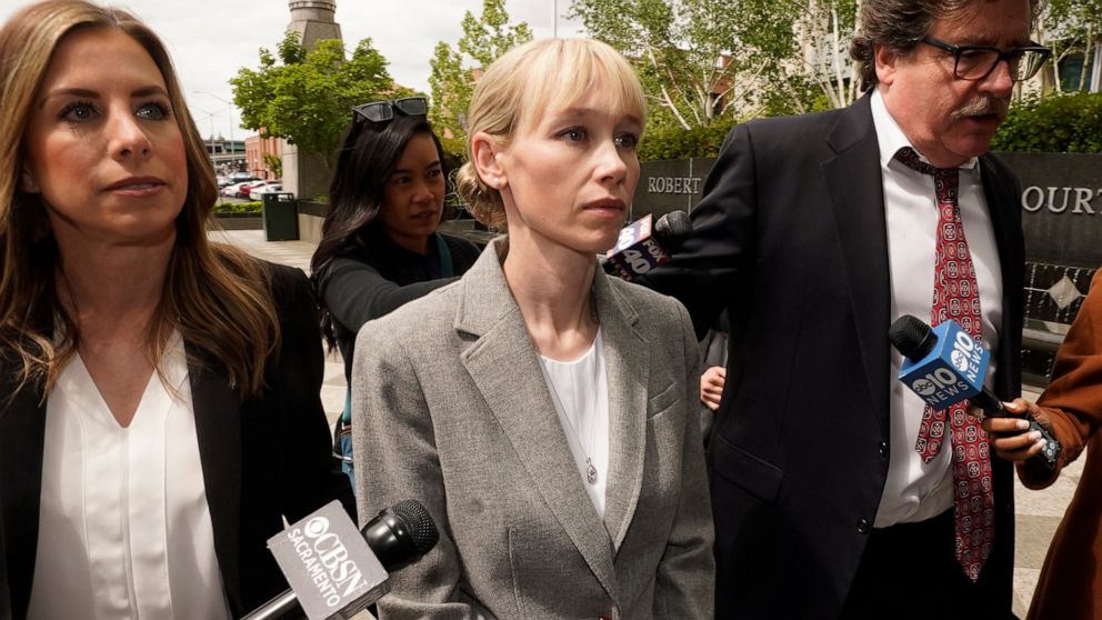 FILE - Sherri Papini of Redding walks to the federal courthouse accompanied by her attorney, William Portanova, right, in Sacramento, Calif., Wednesday, April 13, 2022. Papini is scheduled to appear in federal court, Monday, Sept. 19, 2022, where pro