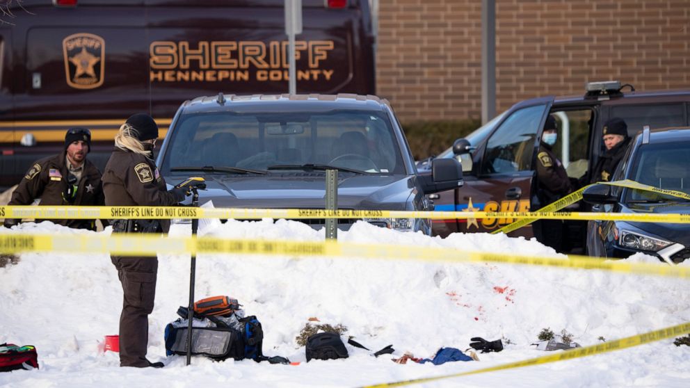 Investigators from Hennepin County Sheriff's Office process the scene of a shooting, Tuesday, Feb. 1, 2022, at the South Education Center, an alternative school in Richfield, Minn. Two students were shot, one of them fatally, outside the suburban Min
