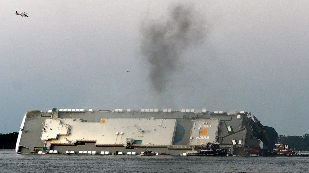 Smoke rises from a cargo ship that capsized in the St. Simons Island, Georgia sound Sunday, Sept. 8, 2019. (Bobby Haven/The Brunswick News via AP)