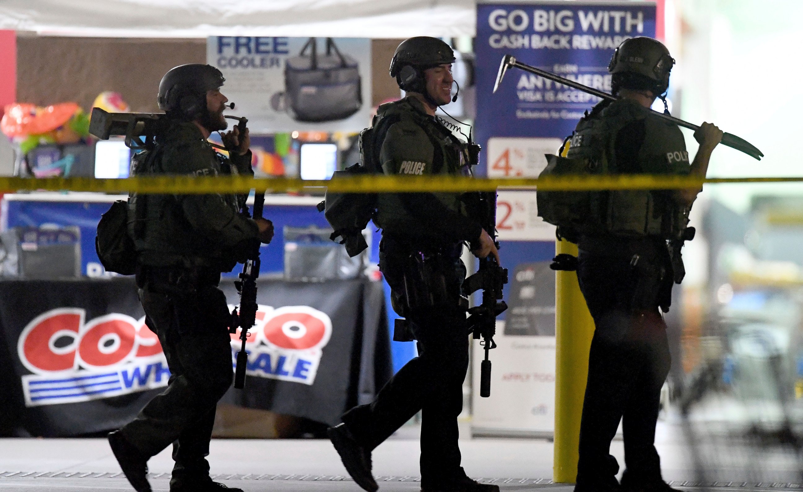 Heavily armed police officers exit the Costco following a shooting inside the wholesale warehouse in Corona, Calif., Friday, June 14, 2019. A gunman opened fire inside the store during an argument, killing a man, wounding two other people and sparkin