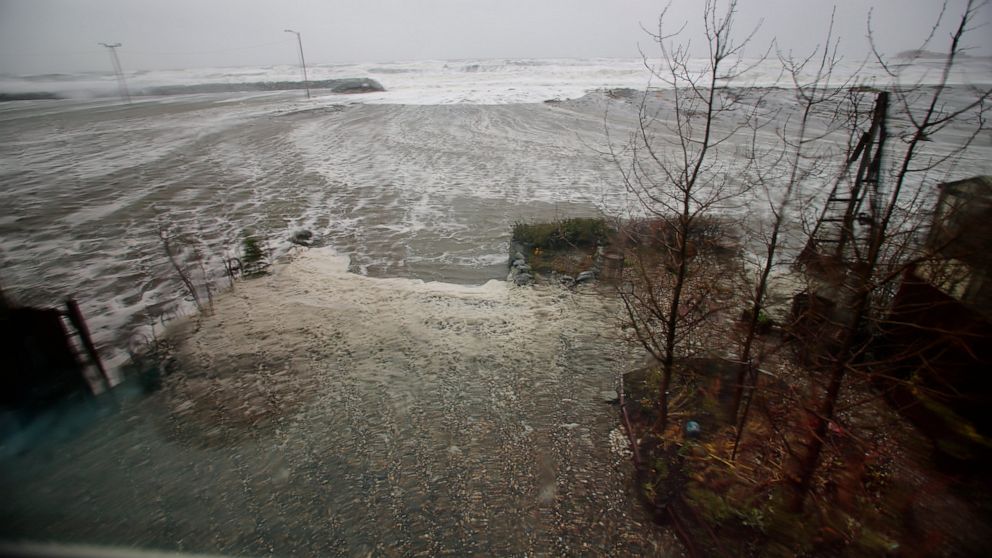 Water from the Bering Sea, pushed by high winds, rushes into a home's backyard in Nome, Alaska, on Saturday, Sept. 17, 2022. Much of Alaska's western coast could see flooding and high winds as the remnants of Typhoon Merbok moved into the Bering Sea 