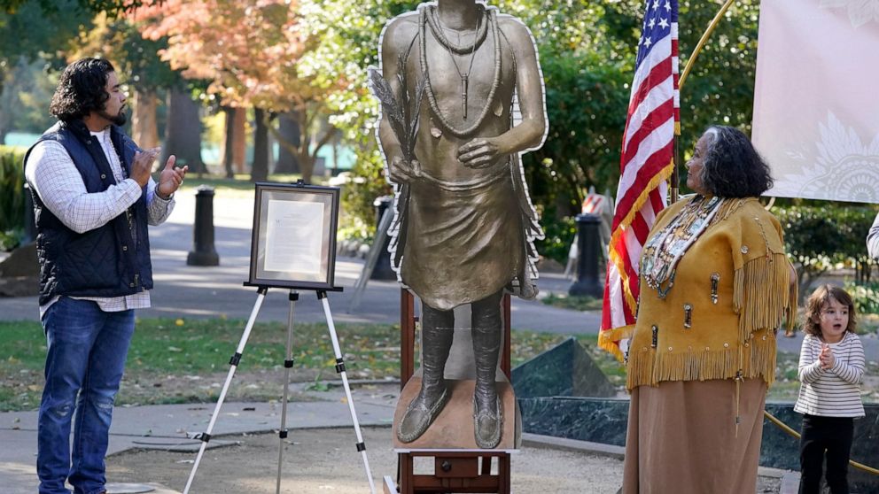 Jesse Tarango, left, chairman of Wilton Rancheria, and his mother Mary Tarango, second from right, look at an enlarged photo of a statue of the late William Franklin Sr. during a groundbreaking ceremony for a Native American monument at Capitol Park 