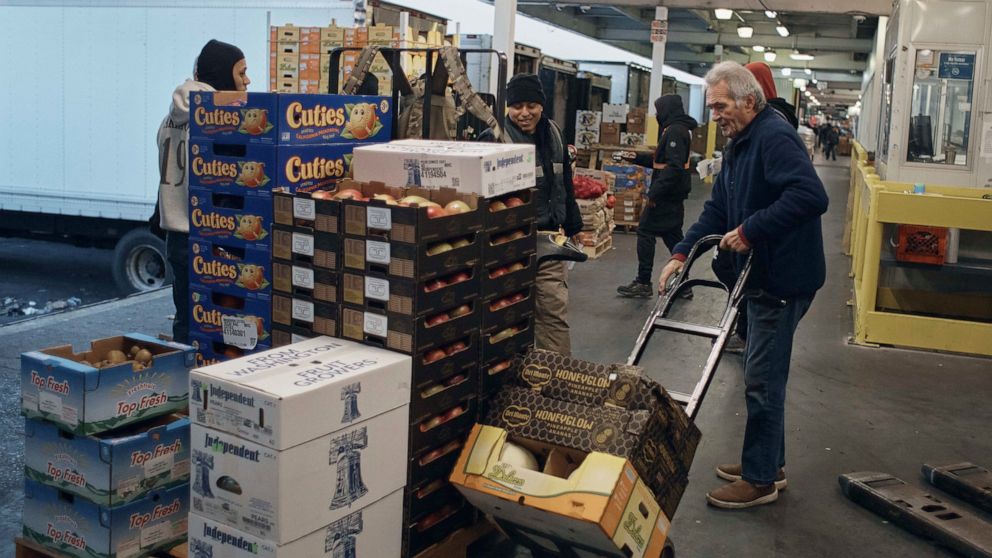 FILE - People shop for fruits and vegetables at S. Katzman Produce at the Hunts Point Produce Market on Tuesday, Nov. 22, 2022, in the Bronx borough of New York. On Tuesday, Dec. 13, the Labor Department reports on U.S. consumer prices for November. 