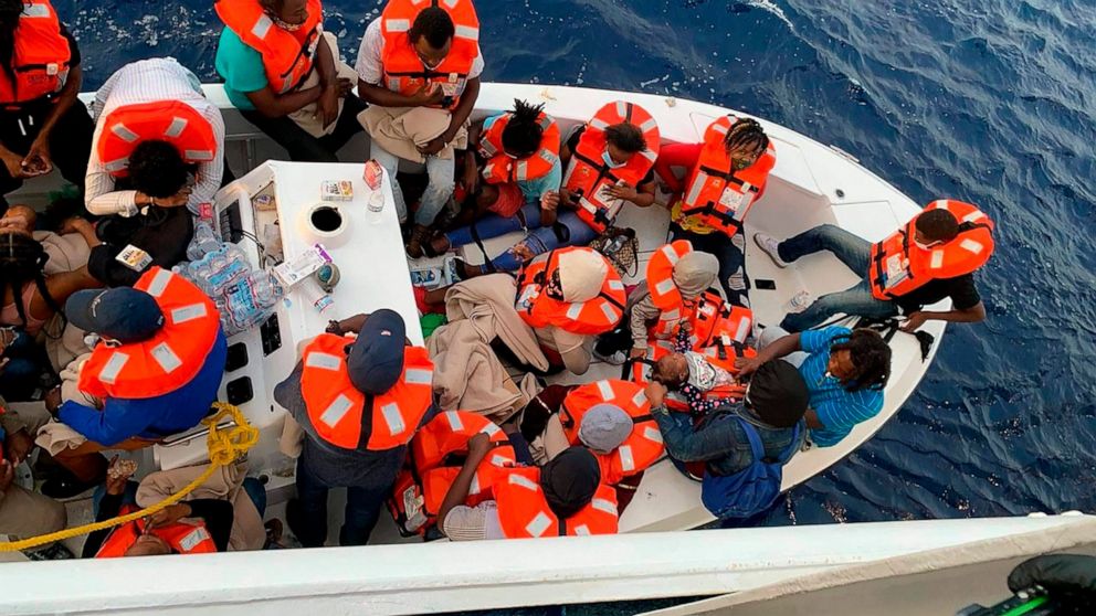This photo provided by Carnival Cruise Line shows people after being rescued by a Carnival Cruise Line ship off the Florida coast, the cruise line reported Saturday, Oct. 17, 2020. It was not immediately clear why the smaller boat came under distress