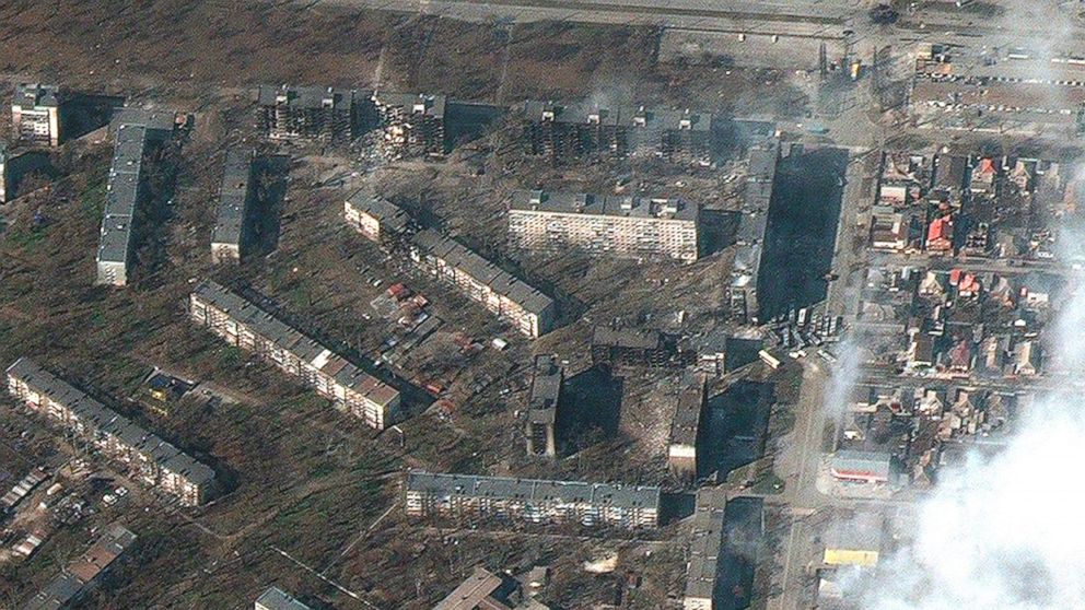 This satellite image provided by Maxar Technologies on Friday, March 18, 2022 shows damaged and burned apartment buildings in Mariupol, Ukraine. (Satellite image ©2022 Maxar Technologies via AP)