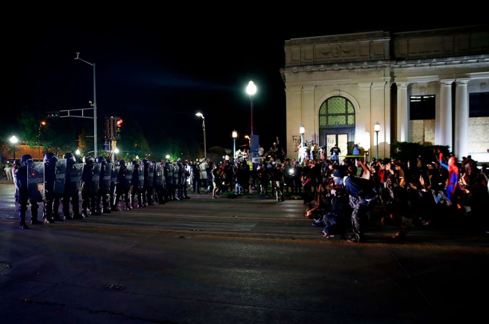 PHOTO: Protestors face off with police outside the County Courthouse during demonstrations against the shooting of Jacob Blake in Kenosha, Wisconsin on August 25, 2020. 