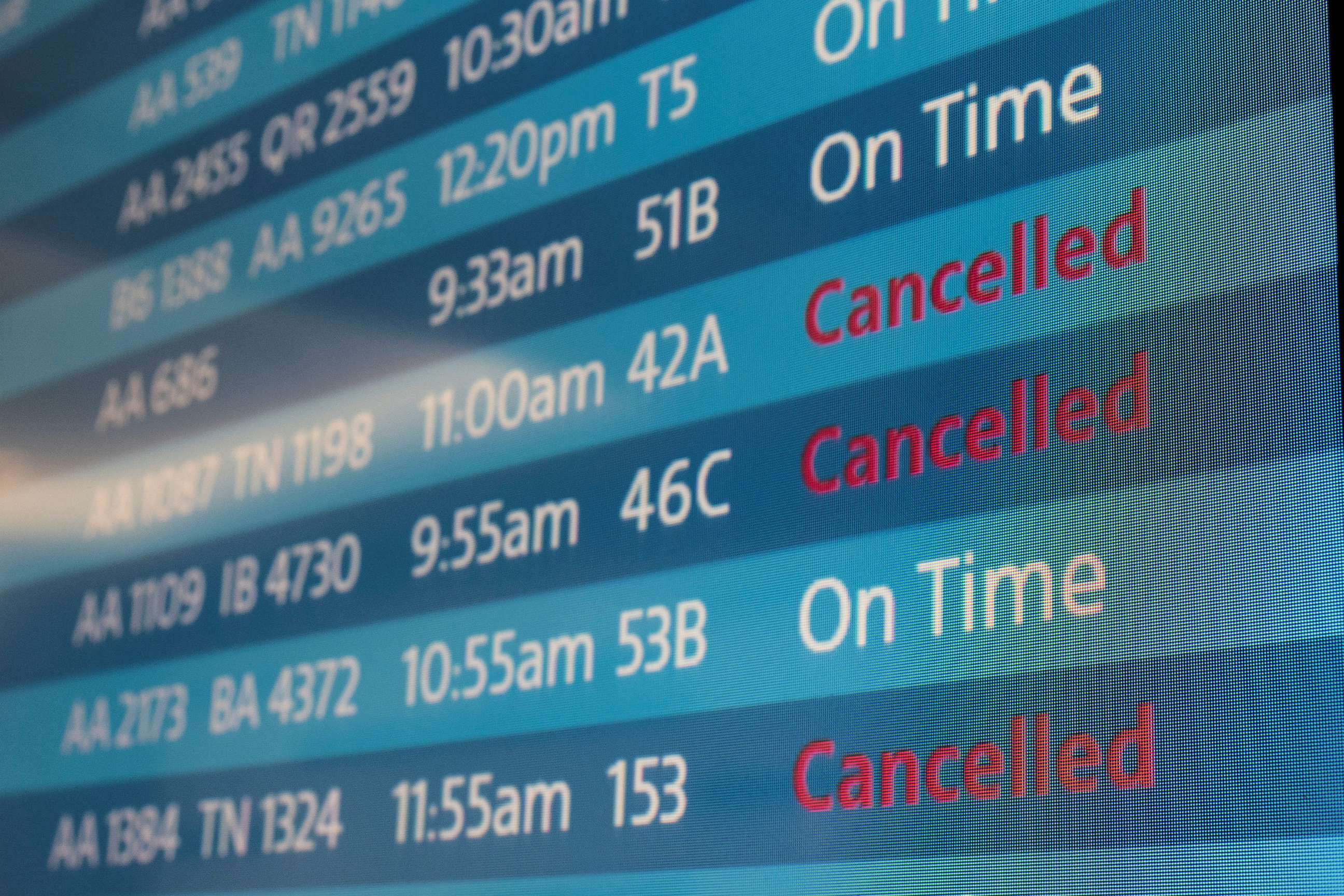 PHOTO: A screen shows cancelled flights at Los Angeles International Airport as more than 1,400 American Airlines flights over the weekend were cancelled due to staff shortages and unfavorable weather, Oct. 31, 2021, in Los Angeles.