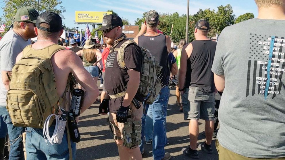 PHOTO: Aaron Danielson, center wearing a black T-shirt and a backpack, stands at a pro-Trump rally in Portland hours before he was killed on Saturday, Aug. 29, 2020.