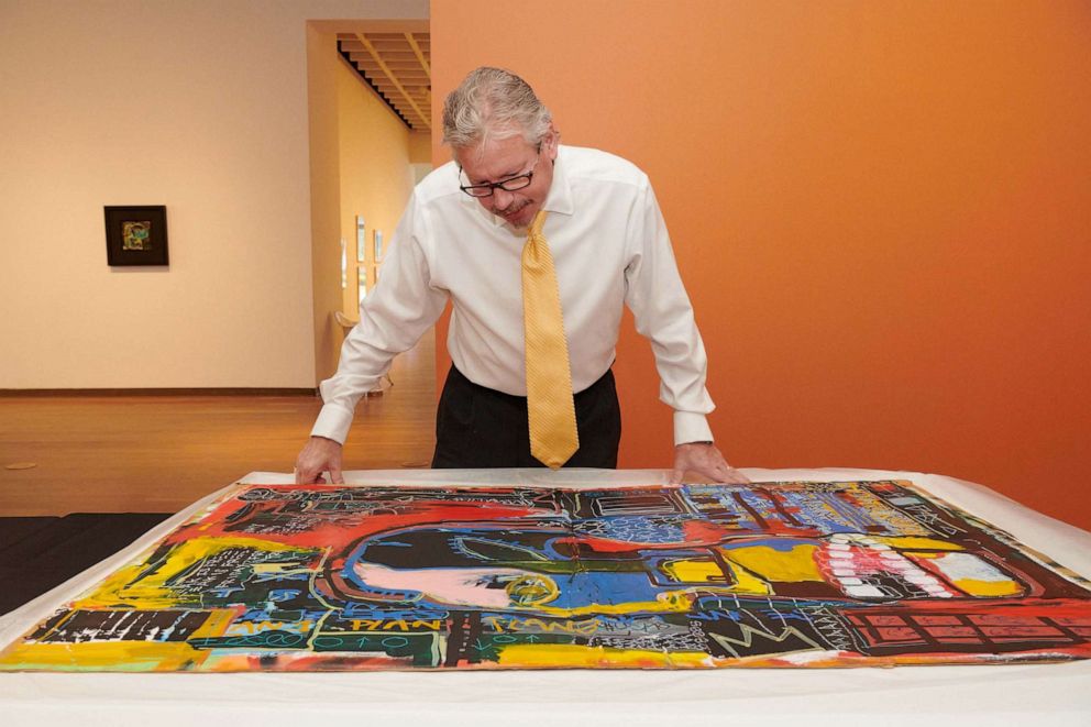 PHOTO: In this Feb. 2, 2022, file photo, Aaron De Groft, director of the Orlando Museum of Art, looks at one of the works from the Mumford storage locker said to be by Jean-Michel Basquiat, "Untitled (Industry Insider)," at the museum in Orlando, Fla.