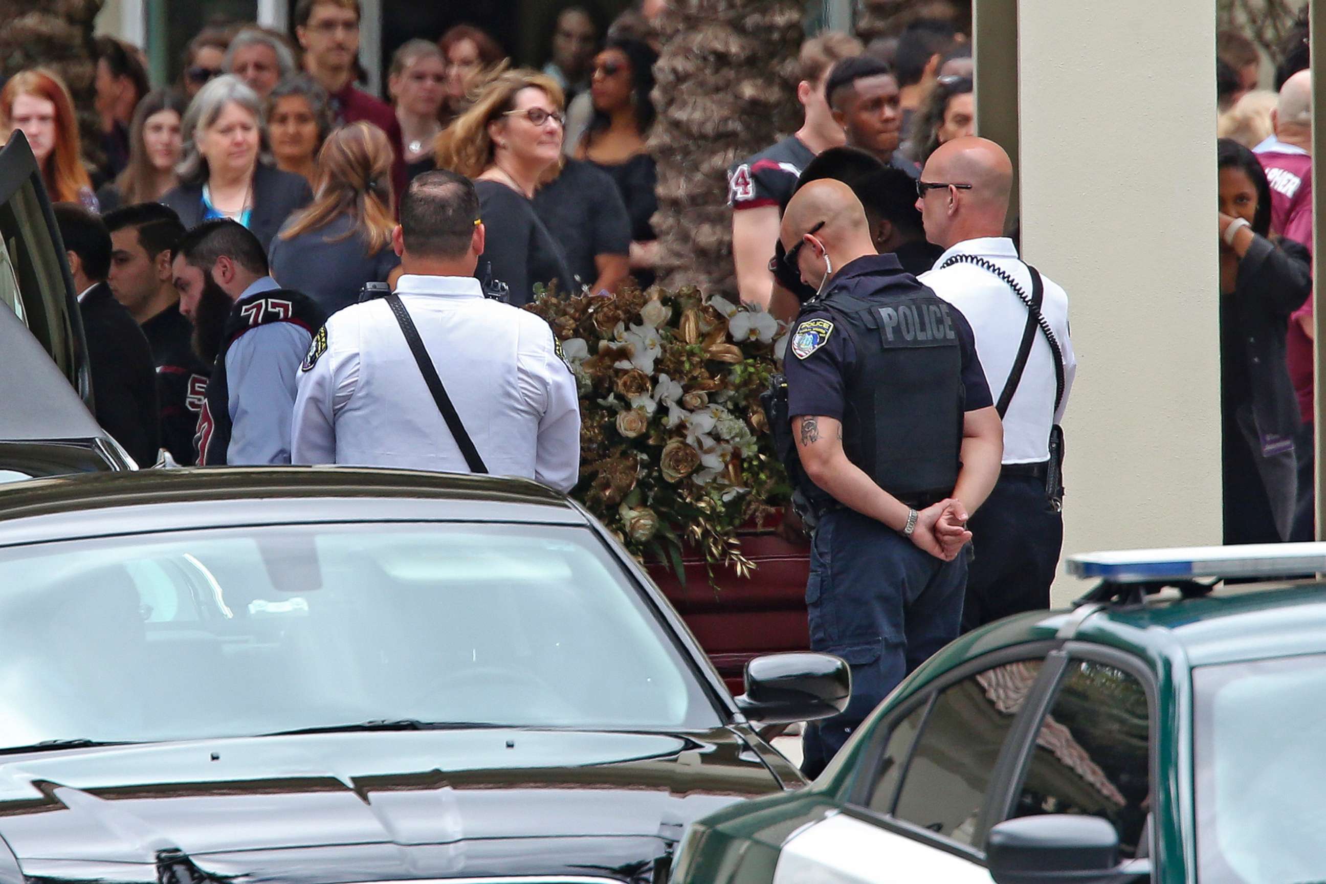 PHOTO: The flower draped casket carrying the body of Aaron Feis, who was killed at Marjory Stoneman Douglas High School, departs the Church by the Glades, Feb. 22, 2018, in Coral Springs, Fla.