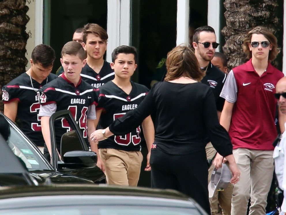 PHOTO: Members of the Marjory Stoneman Douglas High School football team depart the service at the Church by the Glades for Aaron Feis, the football coach who was killed at the school shooting last week, Feb. 22, 2018, in Coral Springs, Fla.
