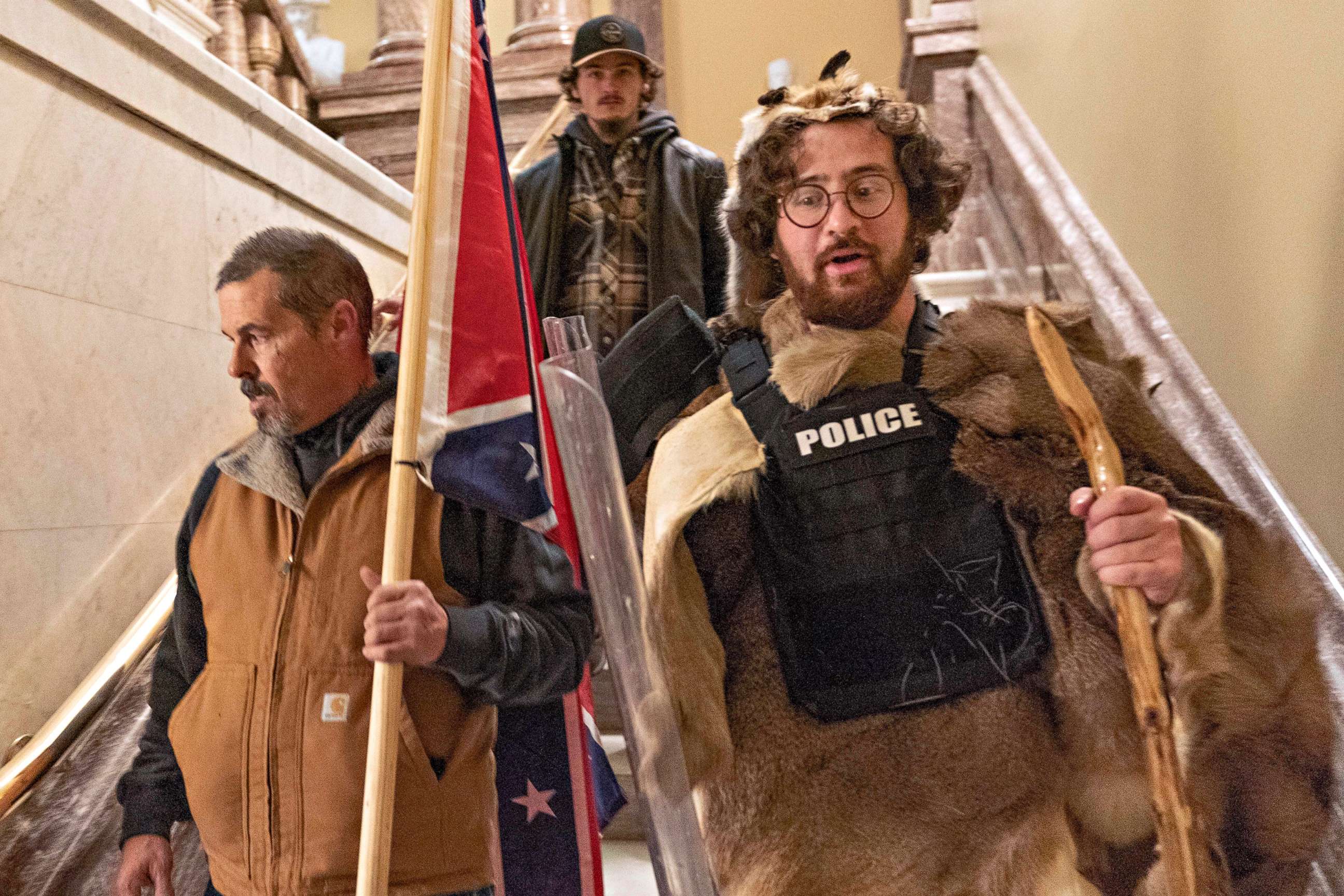 PHOTO: Supporters of President Donald Trump, including Aaron Mostofsky, right, who is identified in his arrest warrant, walk down the stairs outside the Senate Chamber in the U.S. Capitol, in Washington, Jan. 6, 2021.