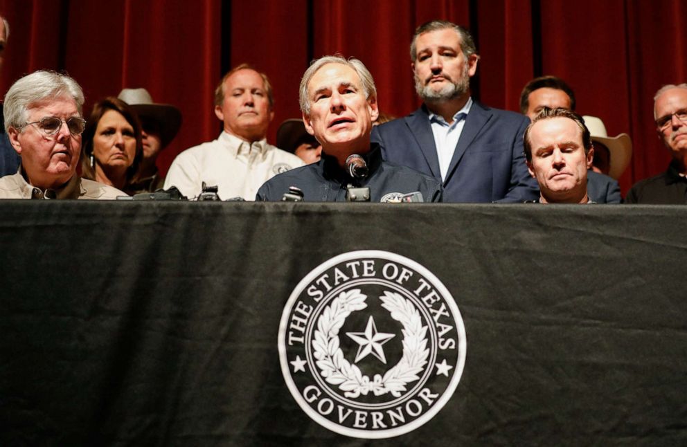 PHOTO: Texas Governor Gregg Abbott is accompanied by Senator Ted Cruz as he speaks to the media at Robb Elementary school, the day after a gunman killed 19 children and two teachers at the school in Uvalde, Texas, May 25, 2022. 