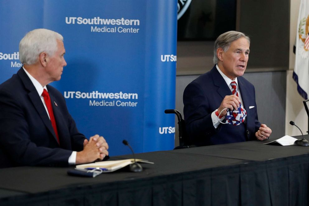 PHOTO: Vice President Mike Pence listens as Texas Gov. Greg Abbott, right, holds up a mask and discusses the importance of wearing one, during a news conference in Dallas, June 28, 2020.