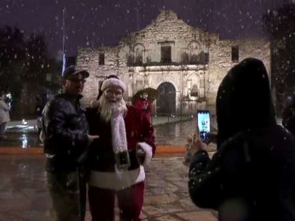 Santa Claus greeted visitors at the Alamo in San Antonio on Thursday evening as rare snow fell in the region.