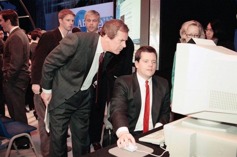 PHOTO: ABC anchor Peter Jennings looks at the digital feed on a monitor during a press conference announcing the creation of ABCNews.com, on May 15, 1997. 