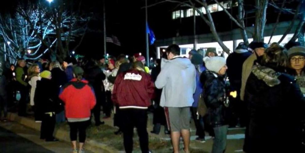 More than 100 people gathered outside NRA headquarters in Fairfax, Va., on Friday night, Feb. 16, 2018, to call for gun control reform.