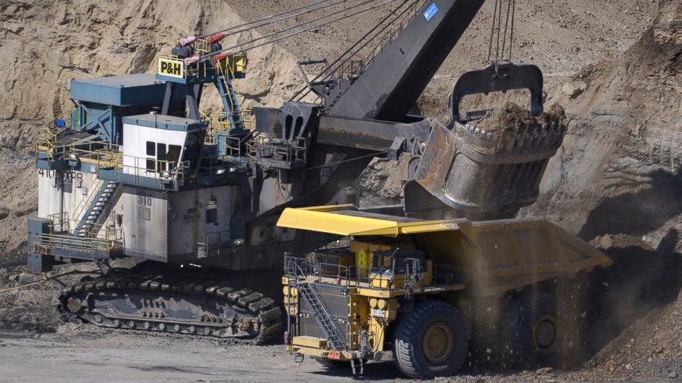 PHOTO: In surface mining, trucks haul dirt and stones, called overburden, from one part to another as other haul trucks move the coal found directly below.