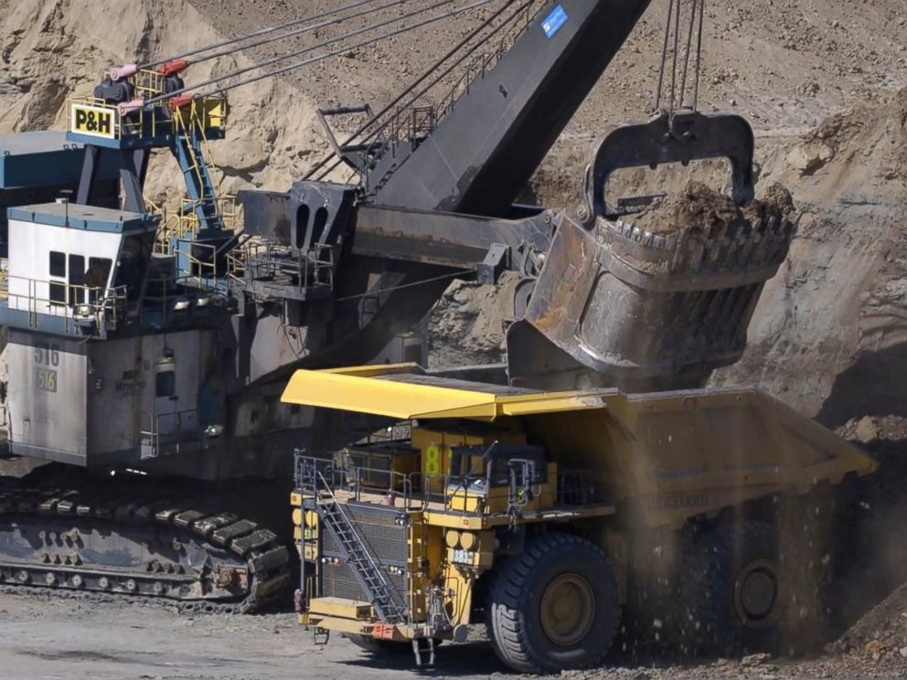 PHOTO: In surface mining, trucks haul dirt and stones, called overburden, from one part to another as other haul trucks move the coal found directly below.