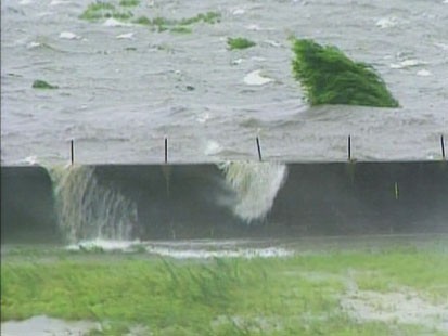 Picture of water topping over levee.
